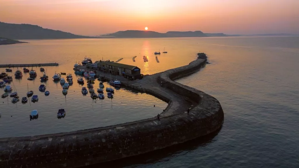 Sunset over Lyme Regis harbour on the Jurassic Coast in Devon