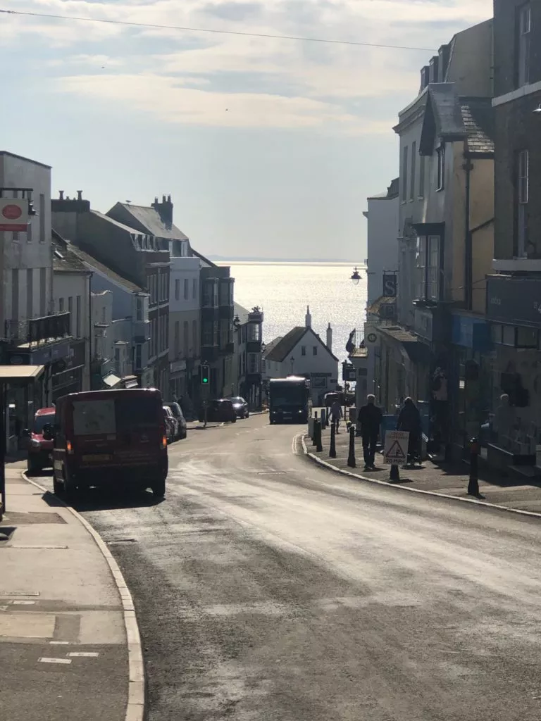 lyme regis high street with sea in the background